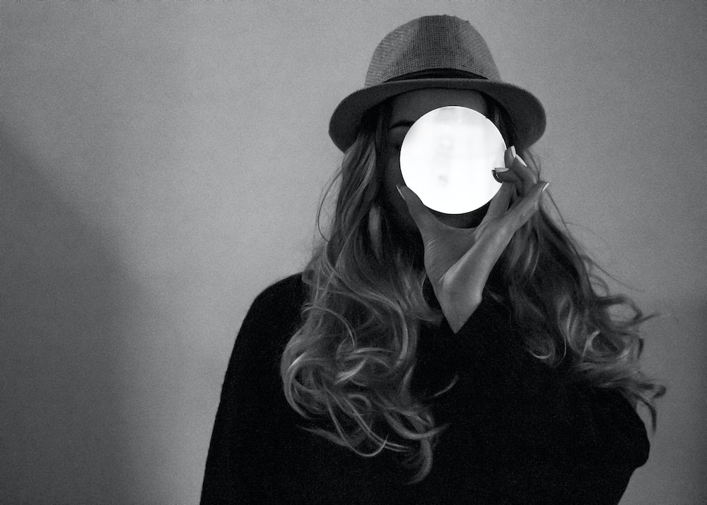 woman in black shirt wearing black hat